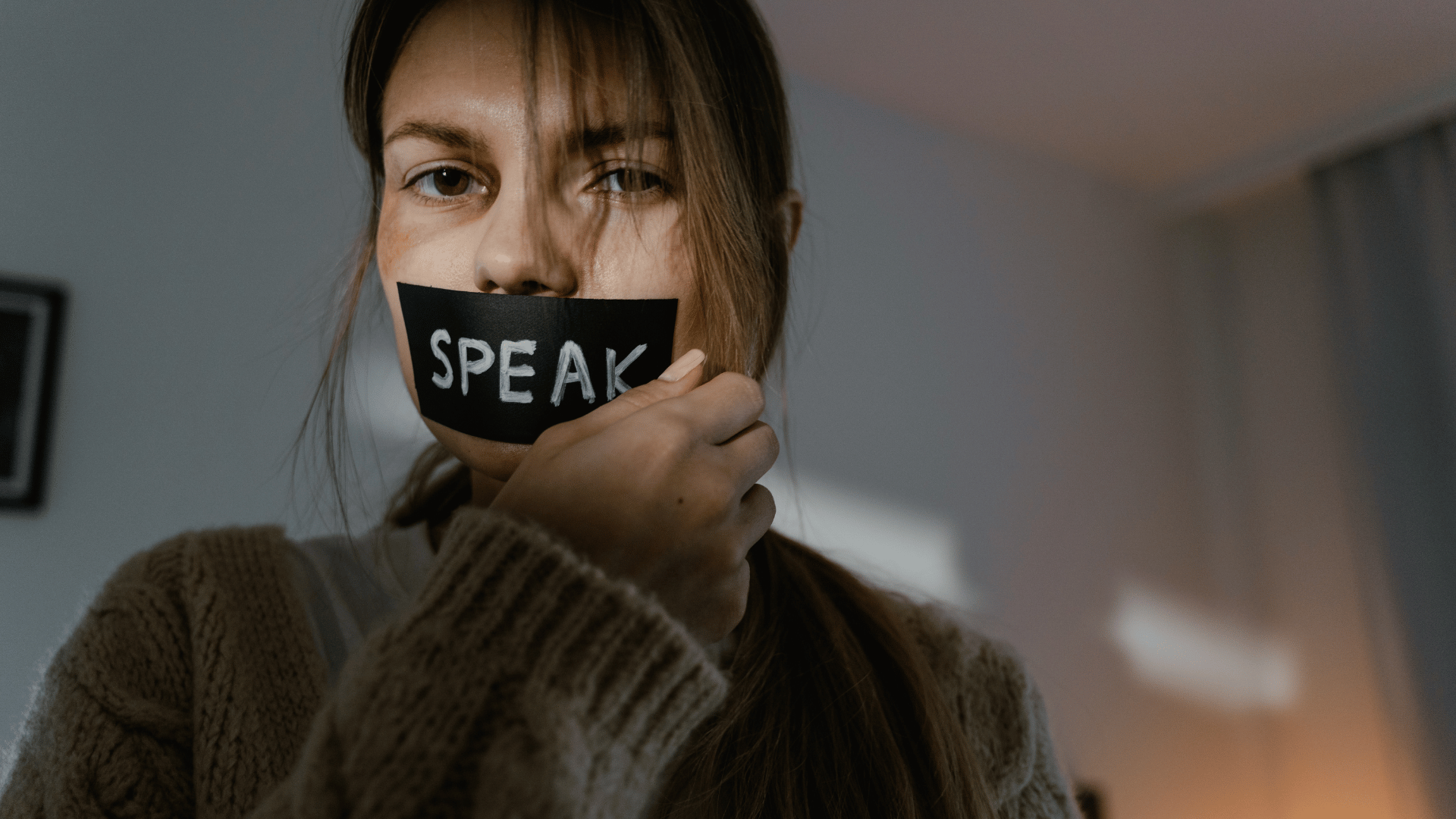 Woman in a quiet room, processing emotions after narcissistic abuse
